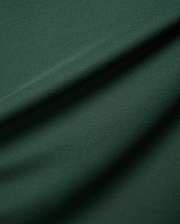 Mens Classic Pique Polo in a deep forest green, highlighting the refined, textured pique fabric with elegant folds, embodying Psycho Bunny's premium streetwear.