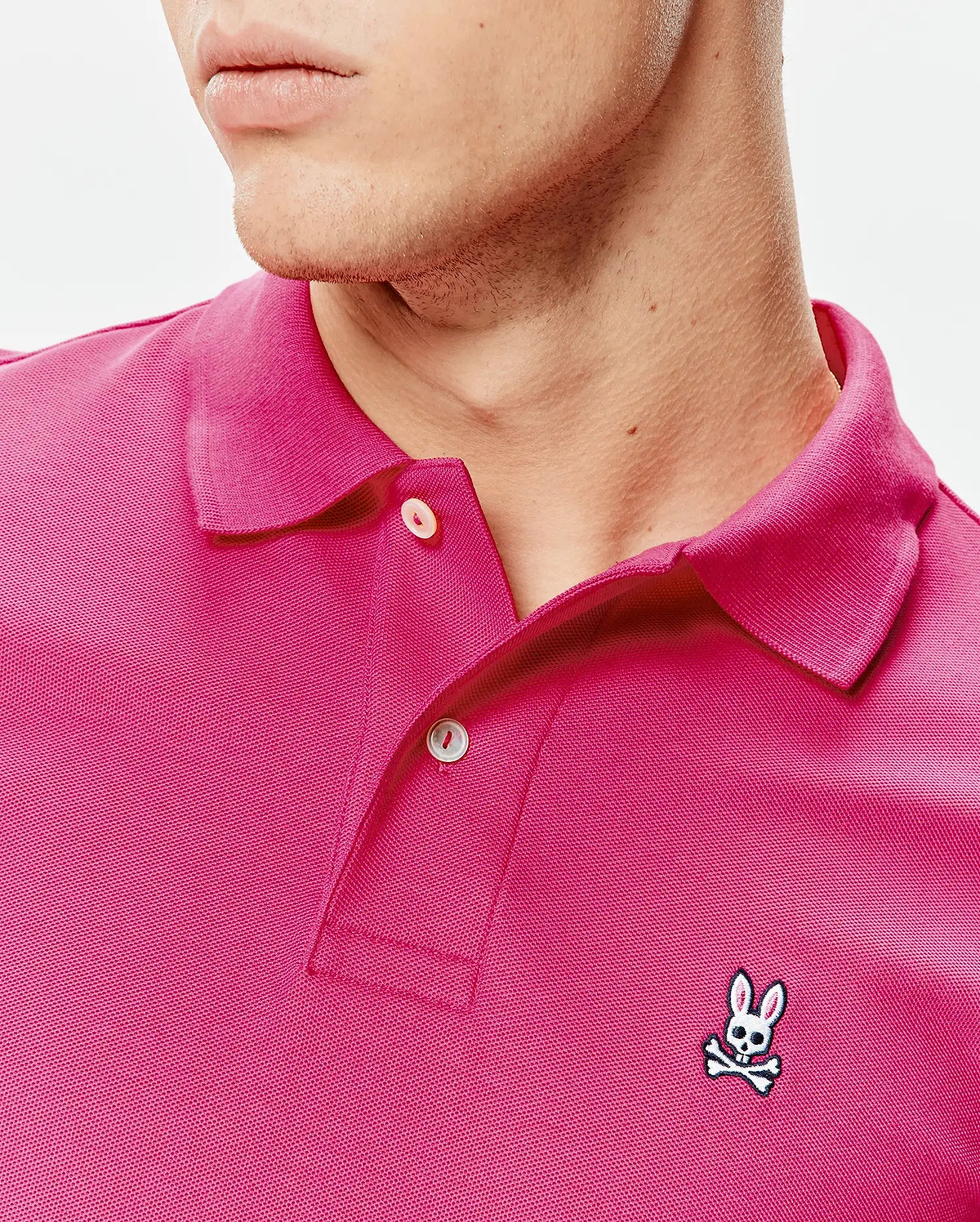 Mens Classic Pique Polo in vibrant fuchsia, featuring a classic fit, pique knit texture, two-button placket, and a small embroidered Psycho Bunny skull logo on the left chest. (3)