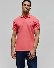 Mens Classic Pique Polo in vibrant coral pique knit, featuring a classic fit, two-button placket, and a small embroidered white Psycho Bunny skull logo on the left chest.