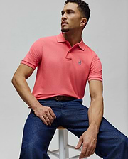 Mens Classic Pique Polo in vibrant coral, featuring a textured pique knit, classic fit, and a small, embroidered Psycho Bunny skull logo on the left chest.