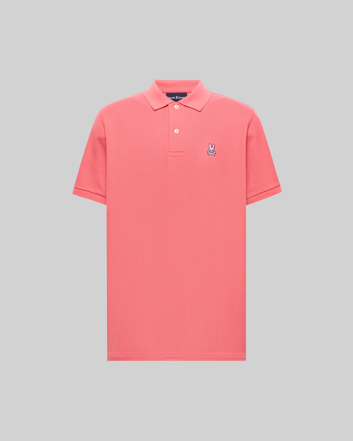 Mens Classic Pique Polo in vibrant coral, featuring a classic fit, pique knit texture, two-button placket, and a small embroidered white and navy Psycho Bunny skull logo on the left chest.