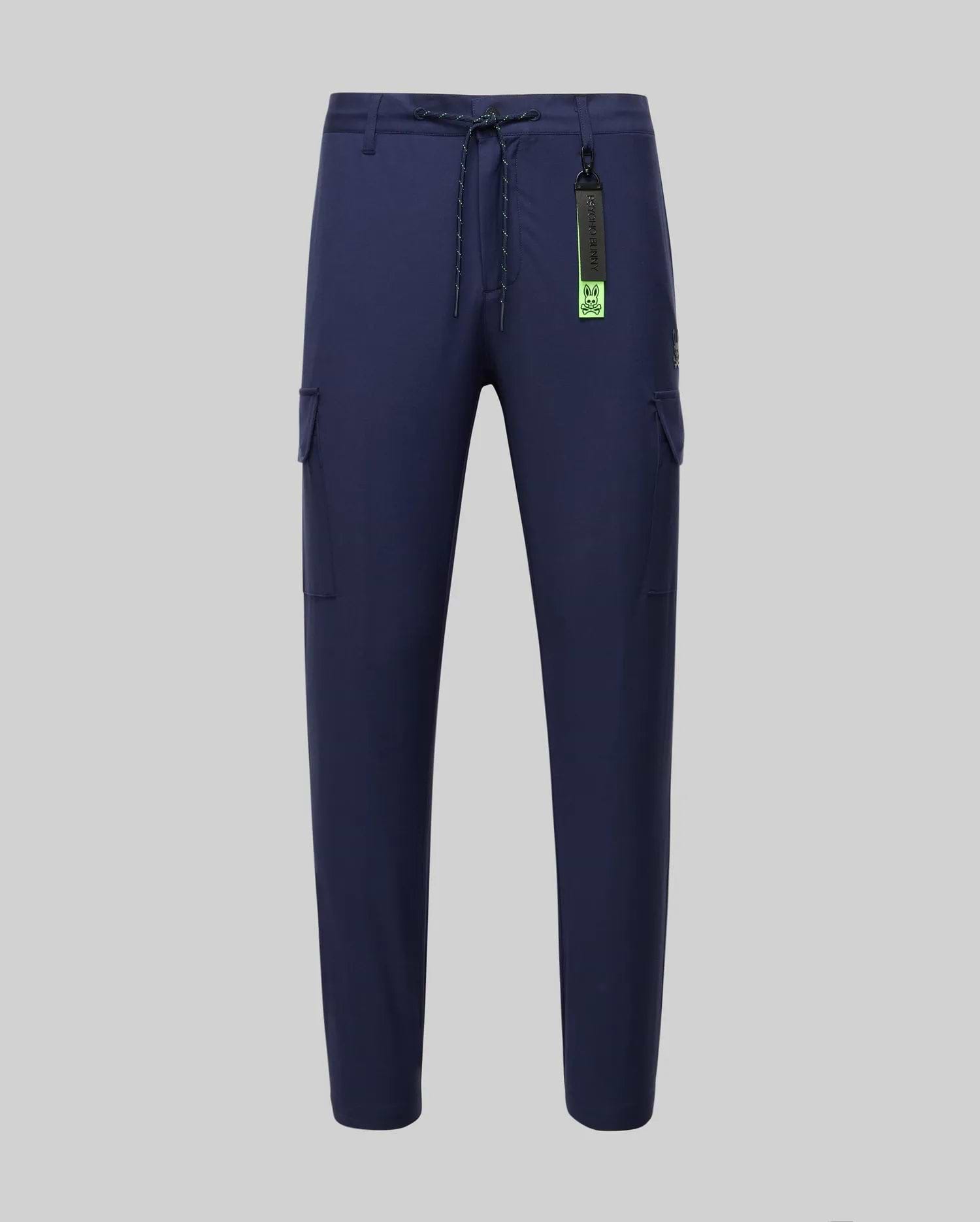 Mens Lloyd Cargo Jogger in navy blue, featuring a relaxed fit, smooth fabric, side cargo pockets, a lime green drawstring, and a prominent Psycho Bunny logo keychain with a small embroidered bunny skull on the pocket.