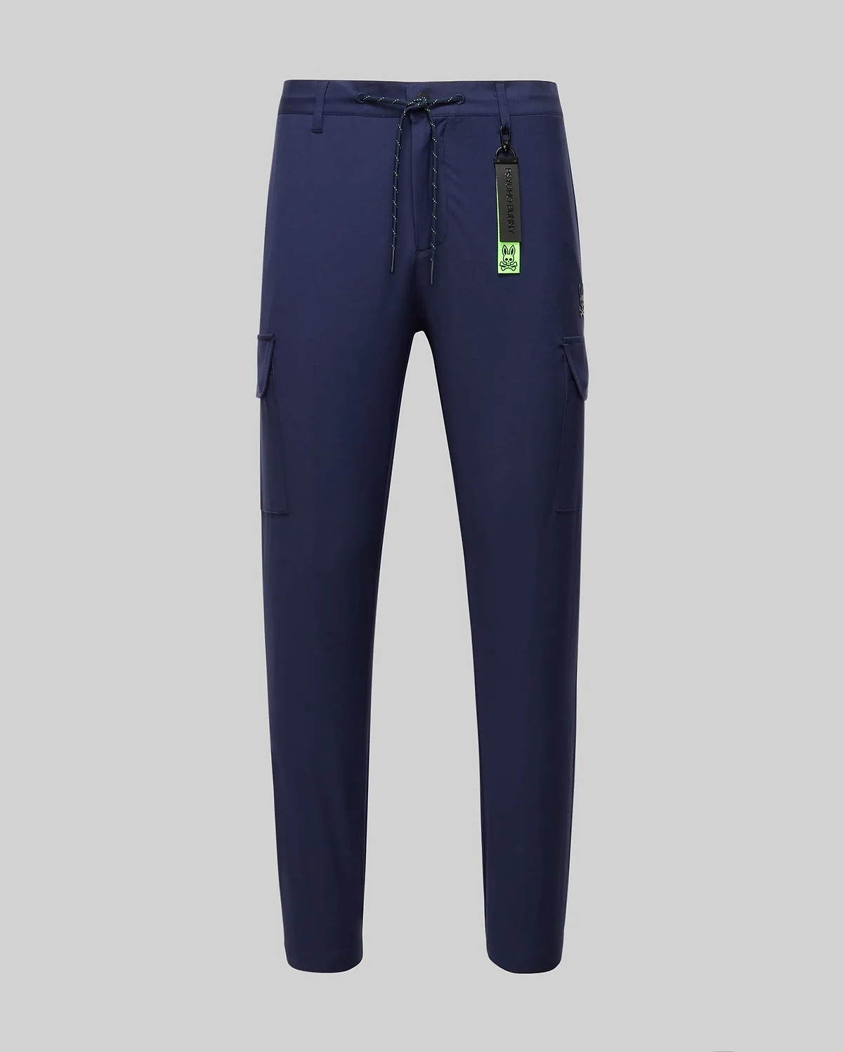 Mens Lloyd Cargo Jogger in navy blue, featuring a relaxed fit, smooth fabric, side cargo pockets, a lime green drawstring, and a prominent Psycho Bunny logo keychain with a small embroidered bunny skull on the pocket.