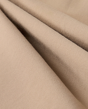 Close-up of beige fabric with a soft, smooth texture and subtle folds. The material appears lightweight and finely woven, suggesting it could be used for clothing or upholstery. The color and texture give a cozy and comfortable impression, making it perfect for the Psycho Bunny MENS LLOYD CARGO JOGGER - B6P159B200's snap fastening pockets.