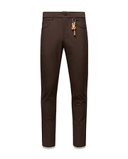 Brown Mens Maverick 10k Step Pant, slim fit, featuring a small red embroidered Psycho Bunny logo on the right front pocket and a prominent brown and orange skull keychain on the left belt loop.