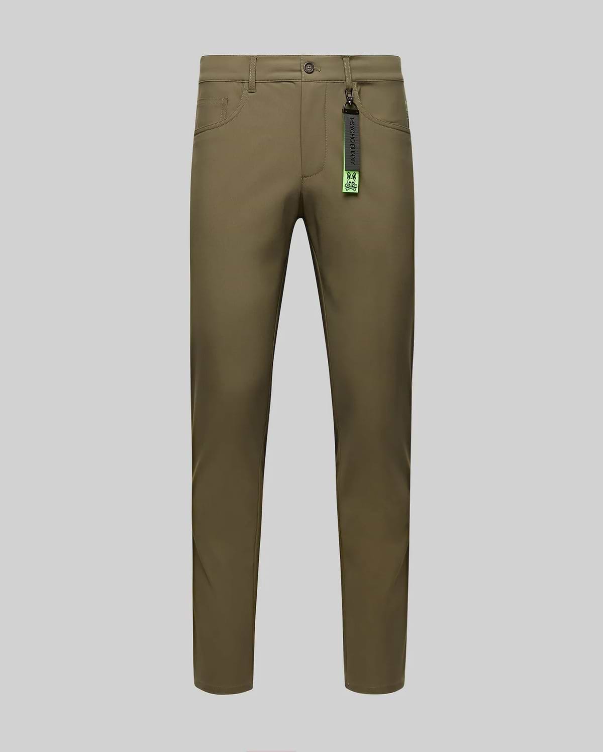 The Psycho Bunny MENS MAVERICK 10K STEP PANT - B6P788D200 in olive green is shown front-facing on a gray background, with slim fit, button and zipper closure, five pockets, belt loops, and a black tag with green accents on the belt loop.