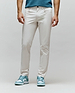 Mens Maverick 10k Step Pant, light beige, slim fit, smooth premium fabric, with a small embroidered green Psycho Bunny skull logo on the right front pocket.