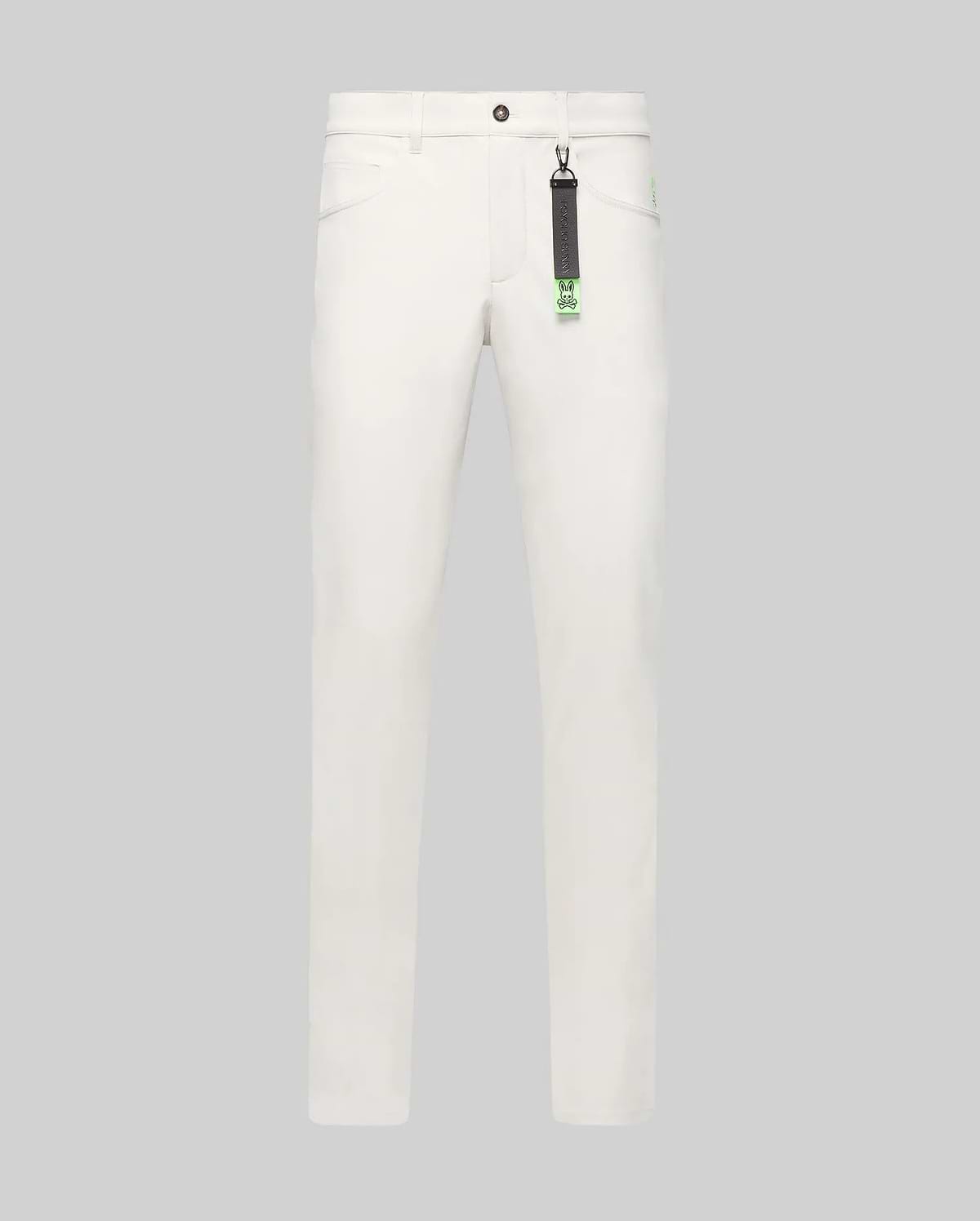 Mens Maverick 10k Step Pant in white, featuring a straight fit, smooth fabric, and a small embroidered neon green Psycho Bunny skull logo on the right hip. A black and neon green branded keychain hangs from a belt loop.