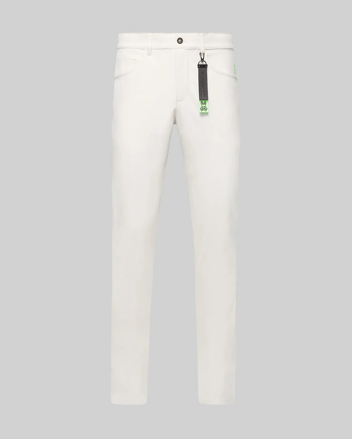 Mens Maverick 10k Step Pant in white, featuring a straight fit, smooth fabric, and a small embroidered neon green Psycho Bunny skull logo on the right hip. A black and neon green branded keychain hangs from a belt loop.