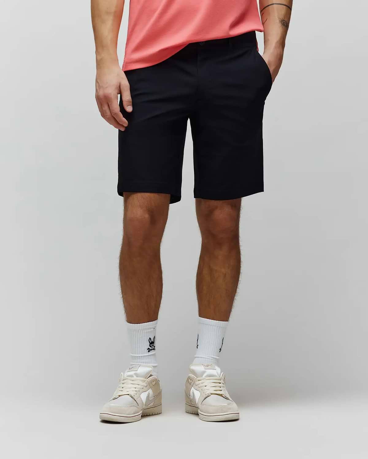 Mens Maverick 10k Step Short, a classic fit black performance stretch short with a smooth, refined finish, featuring a flat front, belt loops, slash pockets, and an above-the-knee length.