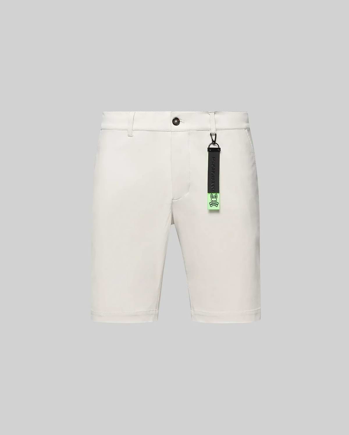 Cream Mens Maverick 10k Step Short, classic fit, smooth woven fabric, featuring button closure, belt loops, and a distinctive black and neon green Psycho Bunny skull logo keychain.