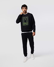 Mens Los Angeles Fleece Sweatshirt in black, featuring a relaxed fit and soft fleece texture, with a bold neon green outlined Psycho Bunny skull and crossbones logo graphic on the chest.