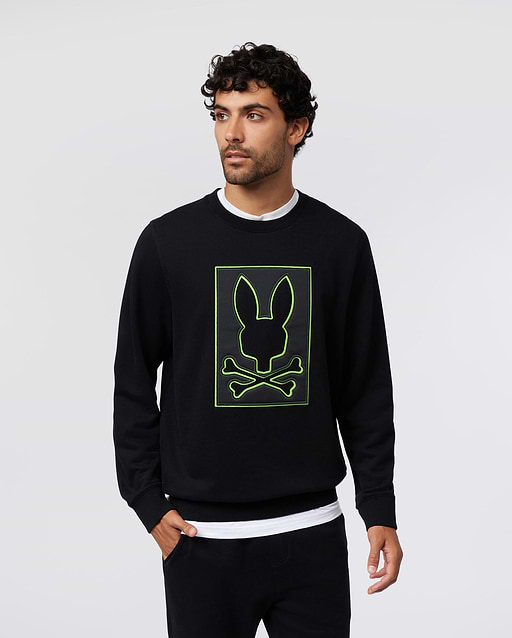 Mens Los Angeles Fleece Sweatshirt in black, featuring a large, centered neon green outline of the Psycho Bunny skull logo on a black patch, classic fit, soft fleece texture.