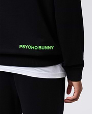 Black Mens Los Angeles Fleece Sweatshirt, relaxed fit, soft fleece texture, featuring a large neon green embroidered PSYCHO BUNNY text logo on the lower side.