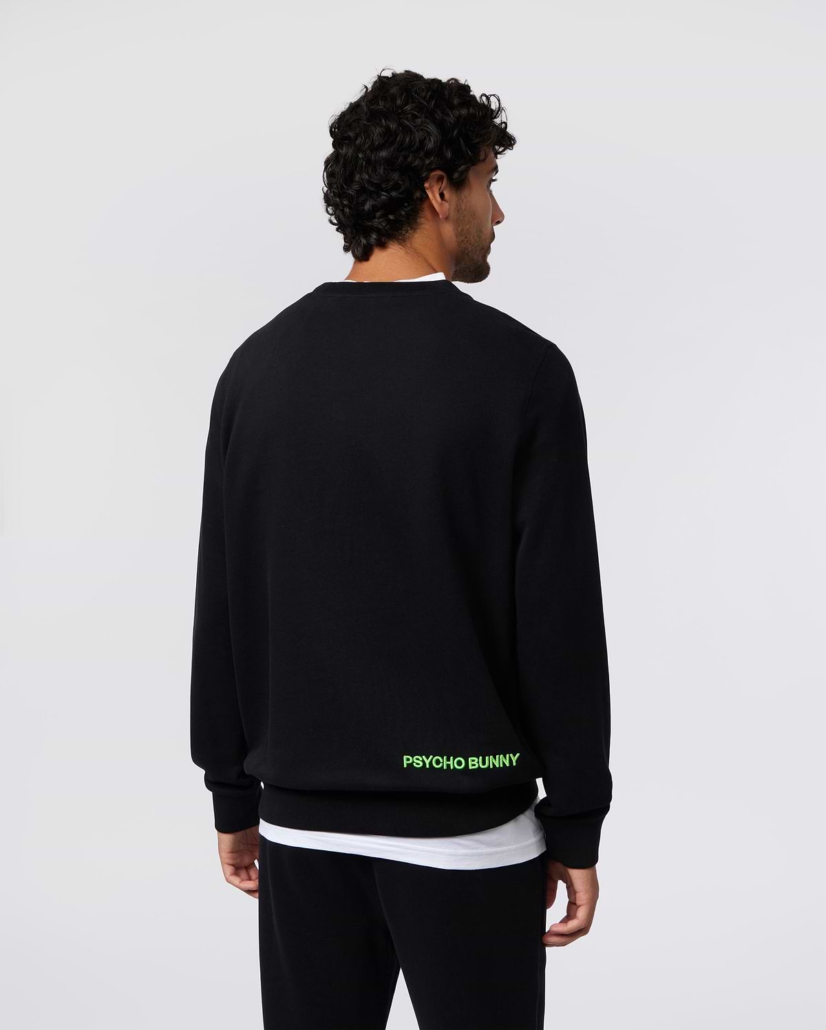 Mens Los Angeles Fleece Sweatshirt, black, relaxed fit, soft fleece, featuring bold neon green PSYCHO BUNNY text branding on the lower back.