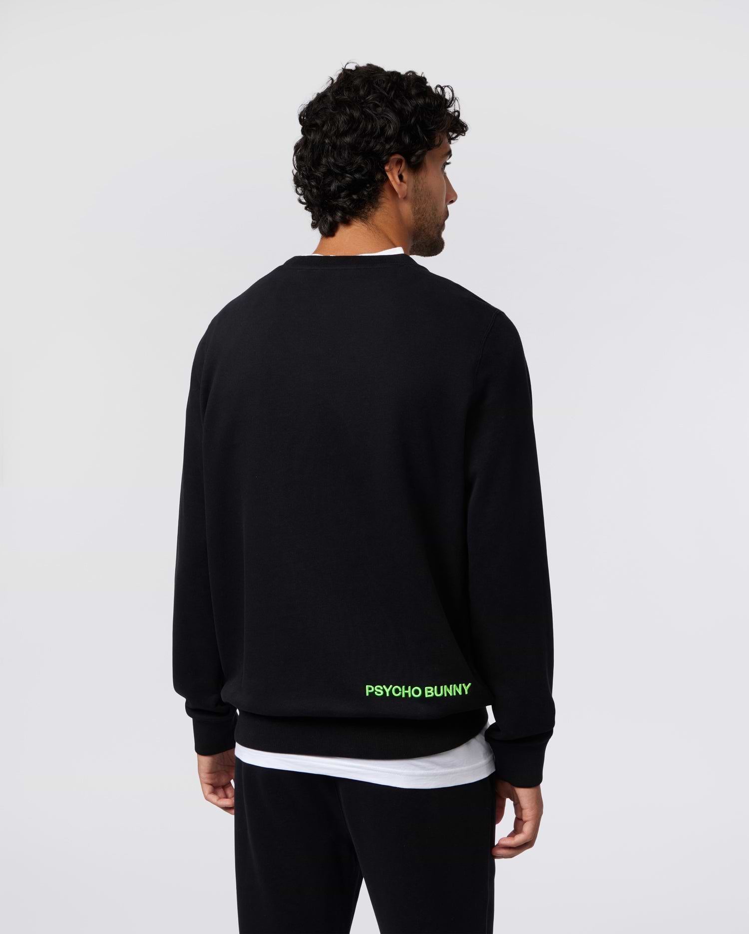 Mens Los Angeles Fleece Sweatshirt, black, relaxed fit, soft fleece, featuring bold neon green PSYCHO BUNNY text branding on the lower back.