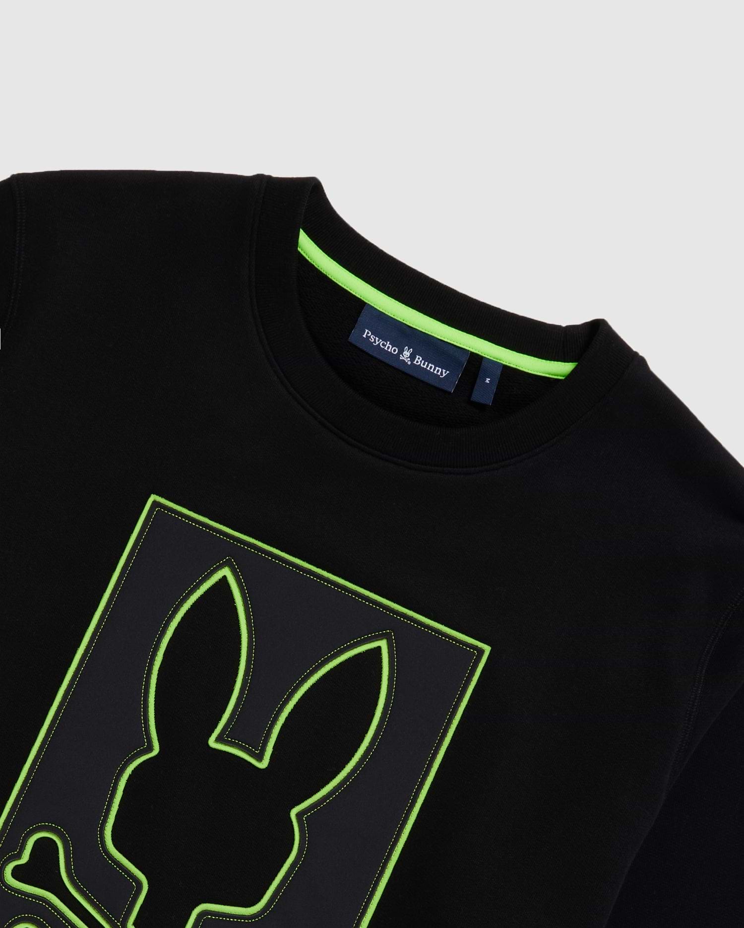 Mens Los Angeles Fleece Sweatshirt, black with a large central embroidered Psycho Bunny skull logo featuring a neon green outline and contrast stitching. Classic fit, soft fleece, and neon green neck tape.