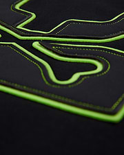 Mens Los Angeles Fleece Sweatshirt in black, featuring a large, raised neon green outline of the iconic Psycho Bunny skull logo with intricate black stitching details on the soft fleece fabric.