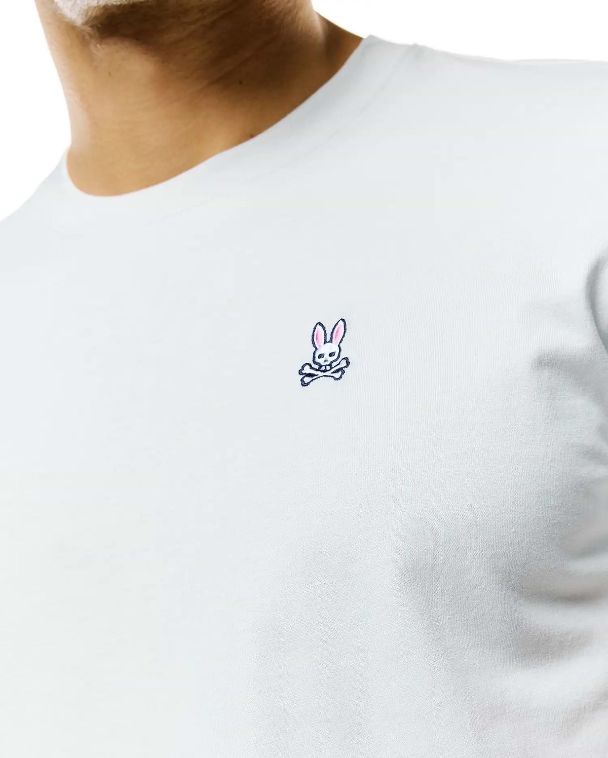 Mens Classic Crew Neck Tee in light blue jersey knit, featuring a classic fit and a small, embroidered Psycho Bunny skull logo with pink ears on the left chest.