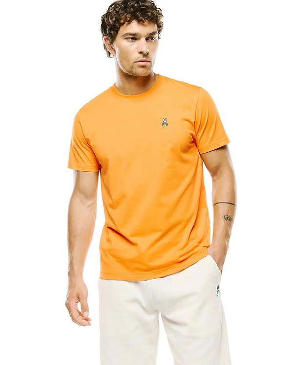 Mens Classic Crew Neck Tee in vibrant orange jersey knit, featuring a classic fit and a small, embroidered Psycho Bunny skull logo on the left chest.