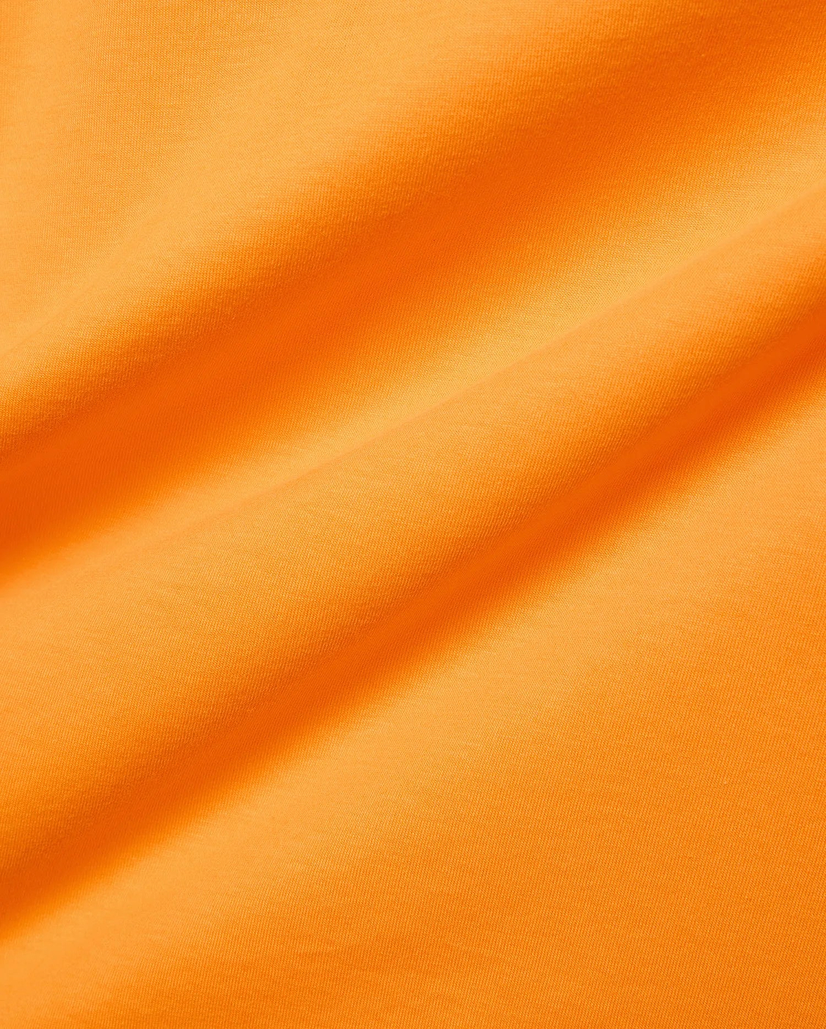 Mens Classic Crew Neck Tee in vibrant orange, crafted from soft jersey knit fabric with subtle folds, reflecting Psycho Bunny's bold, refined streetwear aesthetic.
