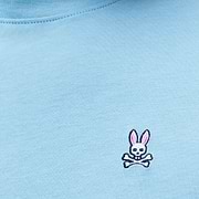 Mens Classic Crew Neck Tee in light blue jersey knit, featuring a small embroidered Psycho Bunny skull logo with pink ears on the left chest, classic fit.