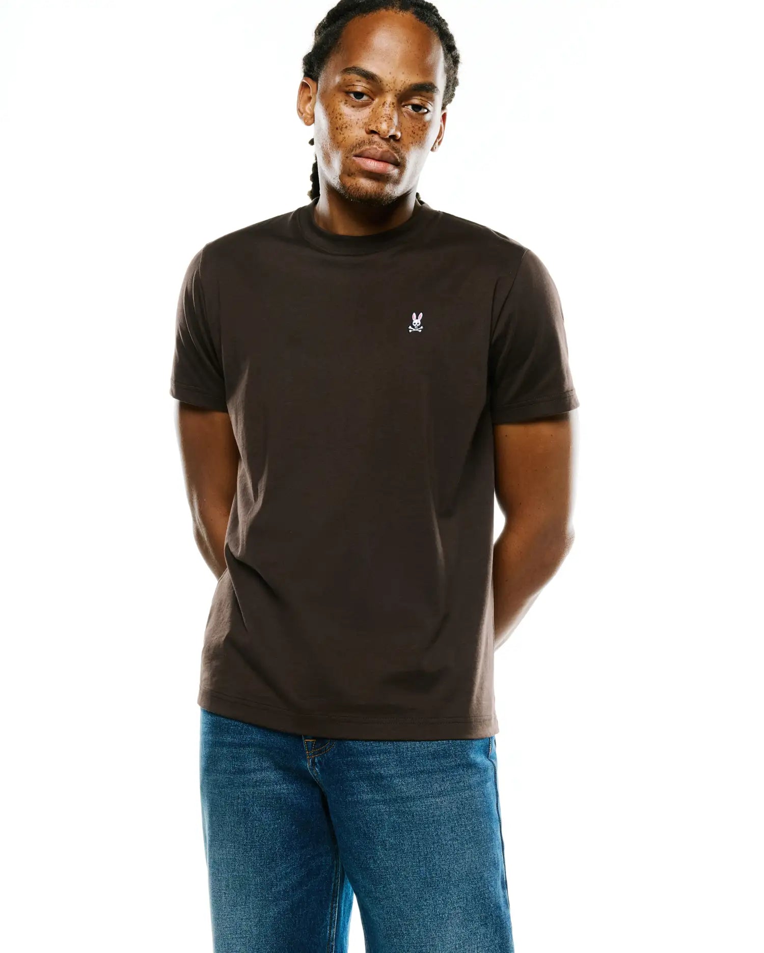 Men's Classic Pima Crew Neck Tee in dark brown, featuring a smooth Pima cotton jersey fabric, classic fit, and a small white embroidered Psycho Bunny skull logo on the left chest. (2)