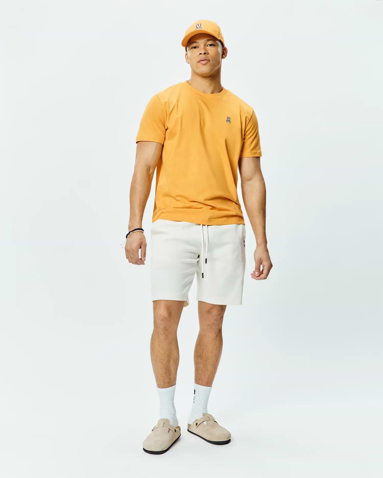 Mustard Yellow Mens Classic Crew Neck Tee in soft jersey knit, featuring a classic fit and a small embroidered black and white Psycho Bunny skull logo on the left chest.