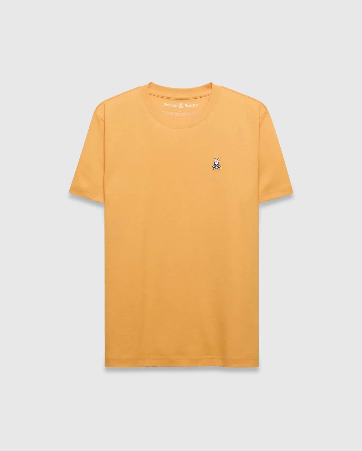 Mens Classic Crew Neck Tee in mustard yellow, featuring a classic fit and smooth jersey fabric. Small embroidered pink, white, and black Psycho Bunny skull logo on the left chest.