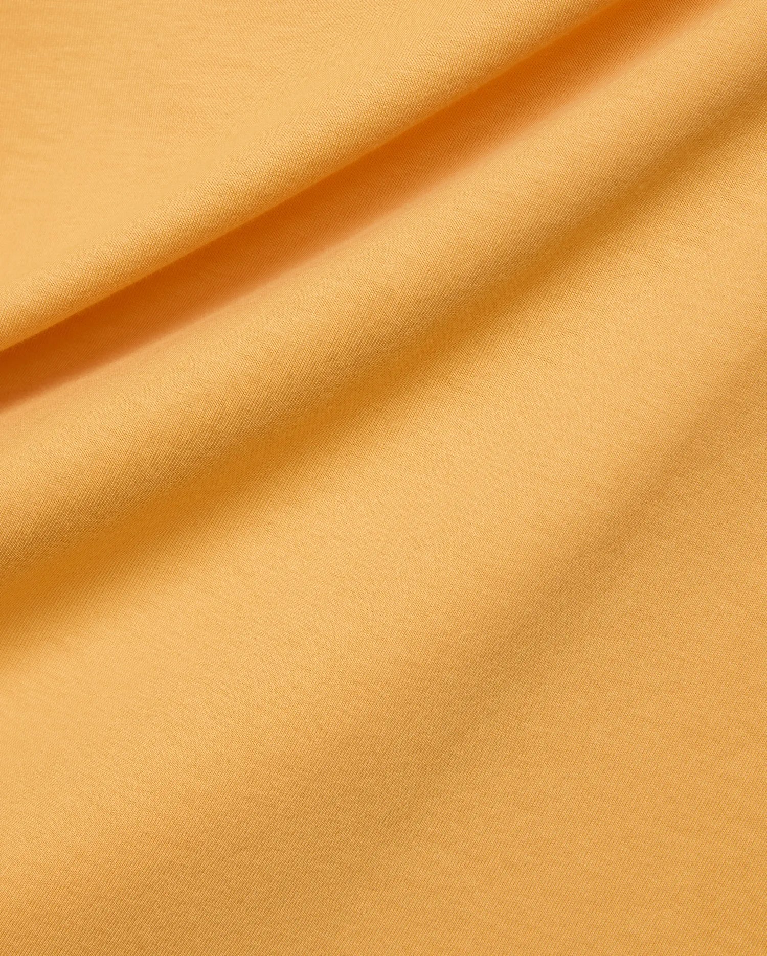 Mens Classic Crew Neck Tee in a rich, vibrant marigold yellow hue, made from a premium, soft-touch jersey knit fabric with a subtle, refined texture.