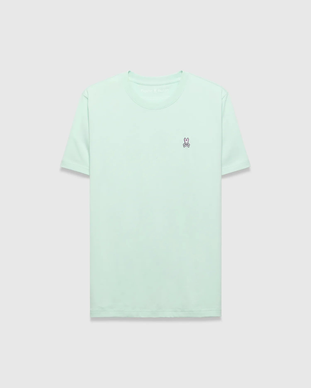 Mens Classic Crew Neck Tee in mint green, featuring a classic fit and soft jersey fabric. A small, embroidered pink and purple Psycho Bunny skull logo is on the left chest.