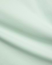 Mens Classic Crew Neck Tee in a premium, soft pale mint green jersey fabric, showcasing a smooth, refined texture with subtle diagonal knit details, characteristic of Psycho Bunny's elevated streetwear.