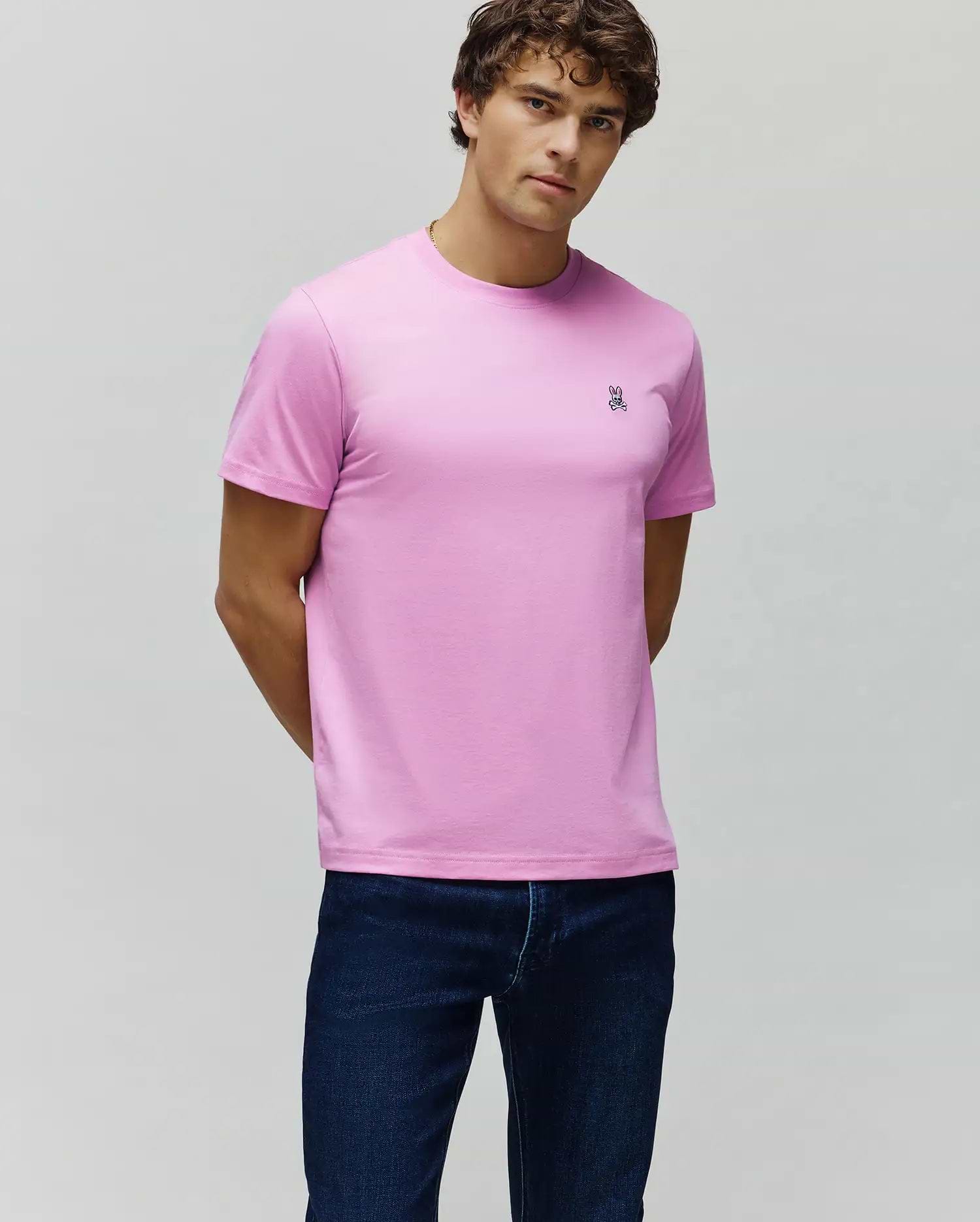 Vibrant Pink Mens Classic Crew Neck Tee, crafted from smooth jersey knit, featuring a classic fit and a small embroidered Psycho Bunny skull logo on the left chest.