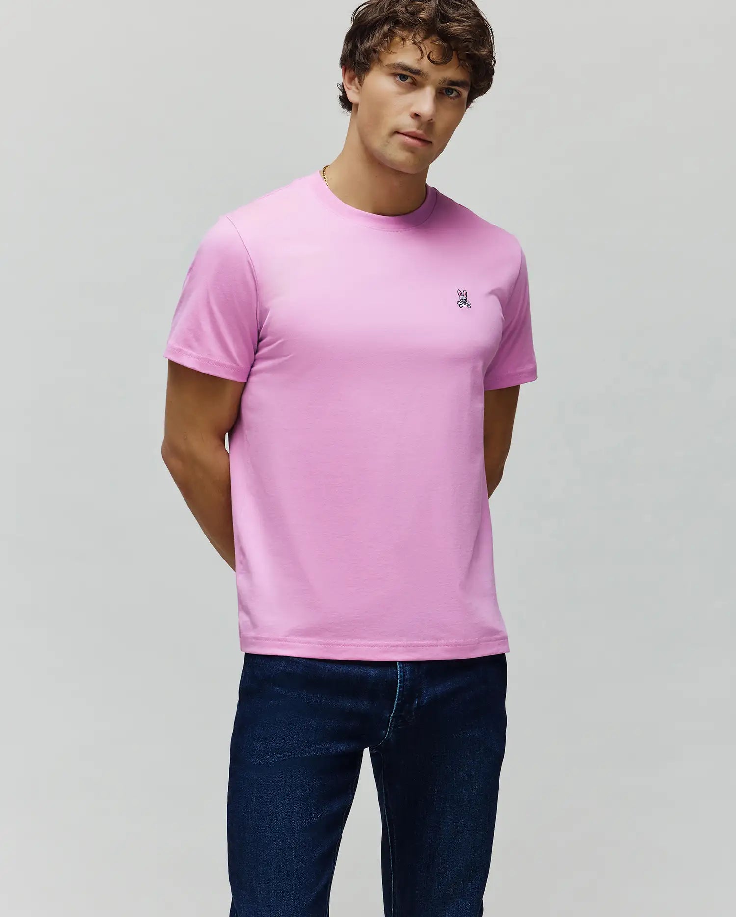 Vibrant Pink Mens Classic Crew Neck Tee, crafted from smooth jersey knit, featuring a classic fit and a small embroidered Psycho Bunny skull logo on the left chest.