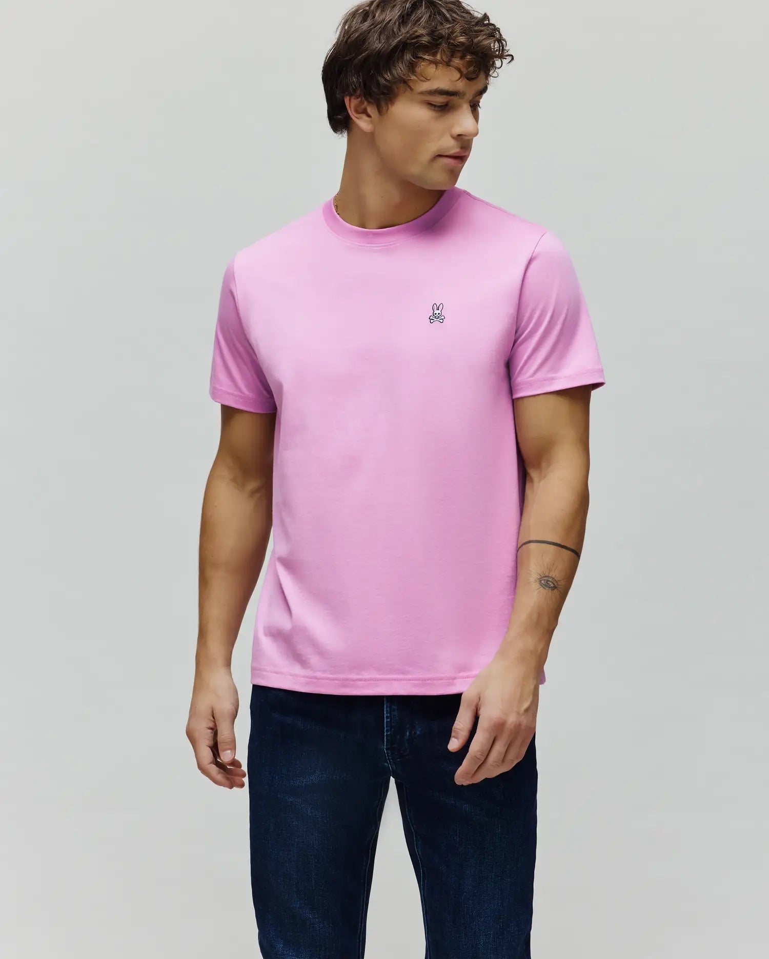 Mens Classic Crew Neck Tee in vibrant pink, featuring a classic fit and smooth jersey knit. A small, embroidered black and white Psycho Bunny skull logo is on the left chest.