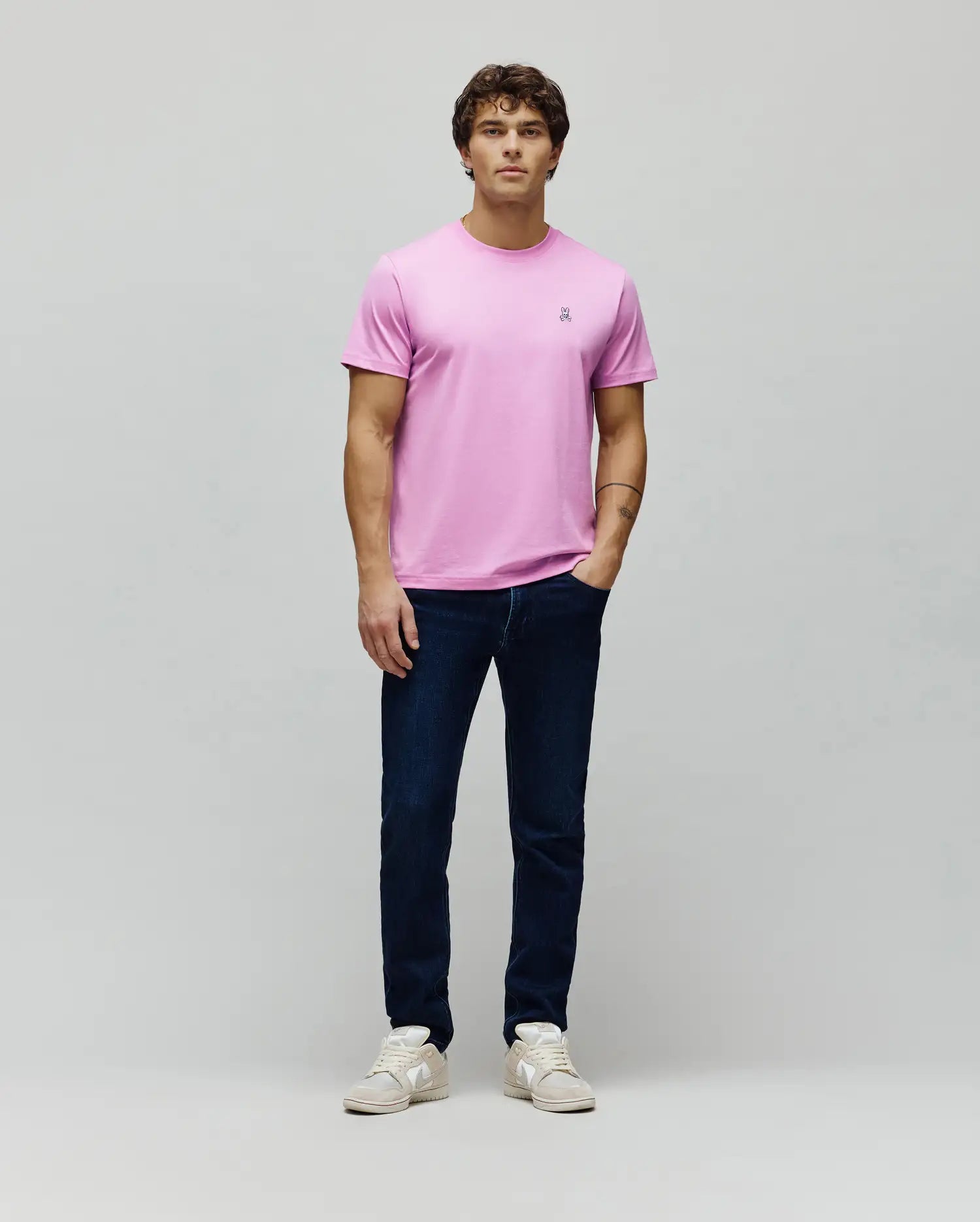 Mens Classic Crew Neck Tee in vibrant pink, featuring a classic fit and smooth jersey knit. Small, multi-color embroidered Psycho Bunny skull logo on the left chest.