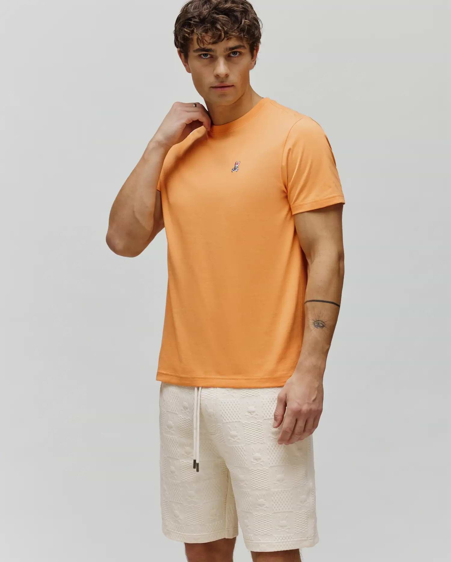 Mens Classic Crew Neck Tee in vibrant orange, featuring a classic fit and smooth jersey fabric, with a small embroidered Psycho Bunny skull logo on the left chest.