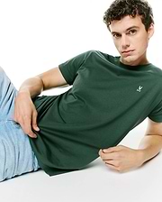 Mens Classic Crew Neck Tee in dark green, featuring a smooth jersey knit and a classic fit, with a small embroidered pink and white Psycho Bunny skull logo on the left chest.