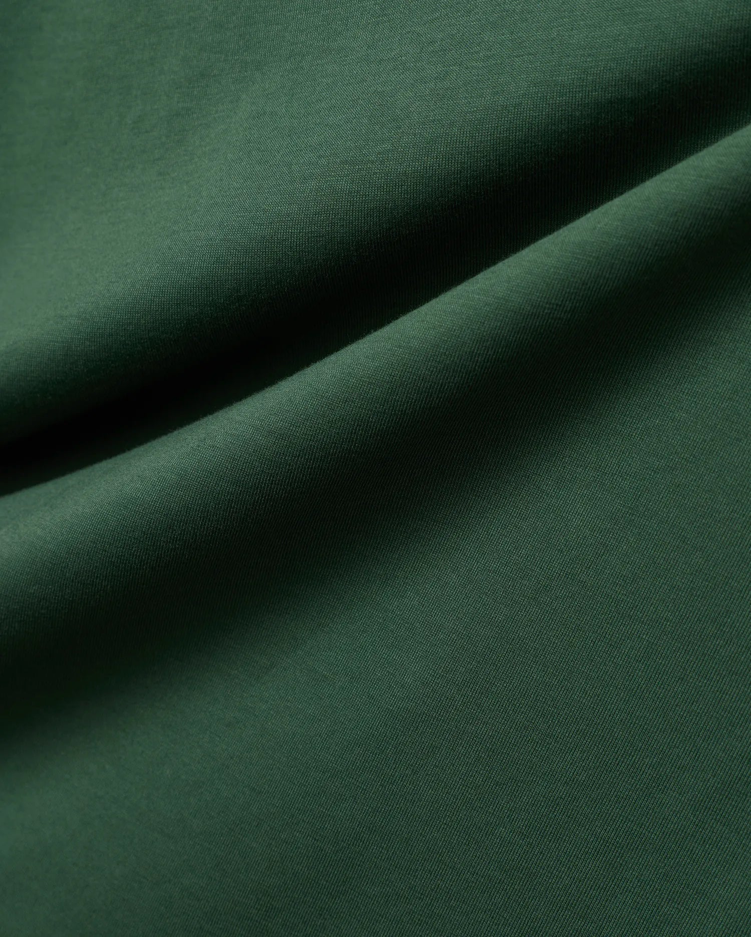 Mens Classic Crew Neck Tee in rich, deep forest green, crafted from premium, soft-touch jersey fabric, showcasing a refined, subtle knit texture and elegant, flowing drapes.