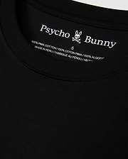 Close-up of the MENS HAWAII CITY TEE by Psycho Bunny, highlighting the black label inside the collar featuring its iconic logo and text indicating it's crafted from 100% Pima cotton, made in Peru.