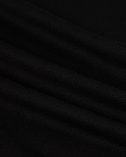Close-up of the MENS HAWAII CITY TEE - B6U169Y1PC by Psycho Bunny, made from black Pima cotton fabric with a smooth, slightly rippled texture. The dark material displays gentle folds and a subtle sheen, resembling the luxurious quality of a sophisticated men's T-shirt for an elegant appearance.