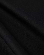 Close-up photo of textured Psycho Bunny Peruvian Pima cotton fabric, showcasing the fine weave and detail of the material.