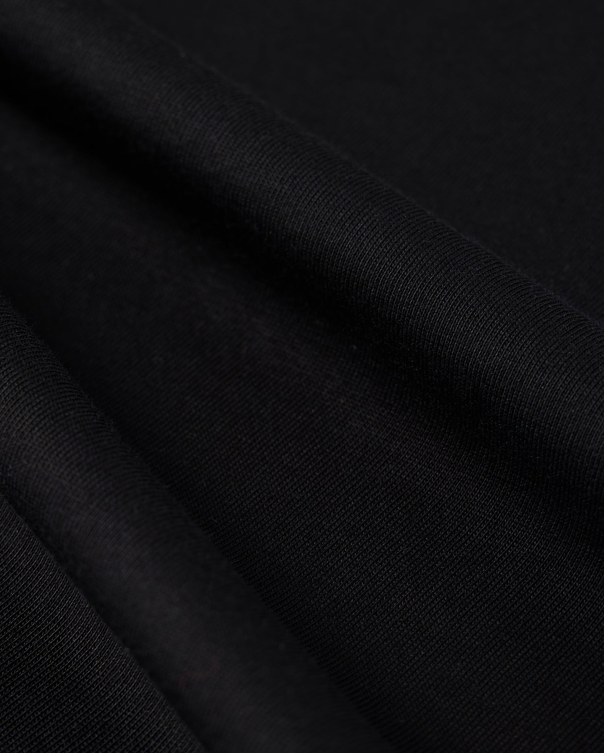 Close-up photo of textured Psycho Bunny Peruvian Pima cotton fabric, showcasing the fine weave and detail of the material.