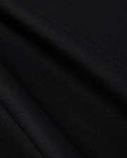 Close-up photo of textured Psycho Bunny Peruvian Pima cotton fabric, showcasing the fine weave and detail of the material.