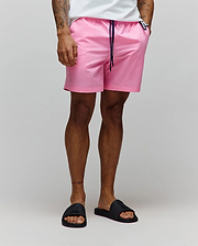 Mens Samos Hydrochromic Printed Swim Trunk in pink, featuring a relaxed fit, smooth quick-dry fabric, navy drawstring with white Psycho Bunny branding, and a small black bunny skull logo tag on the right hip.
