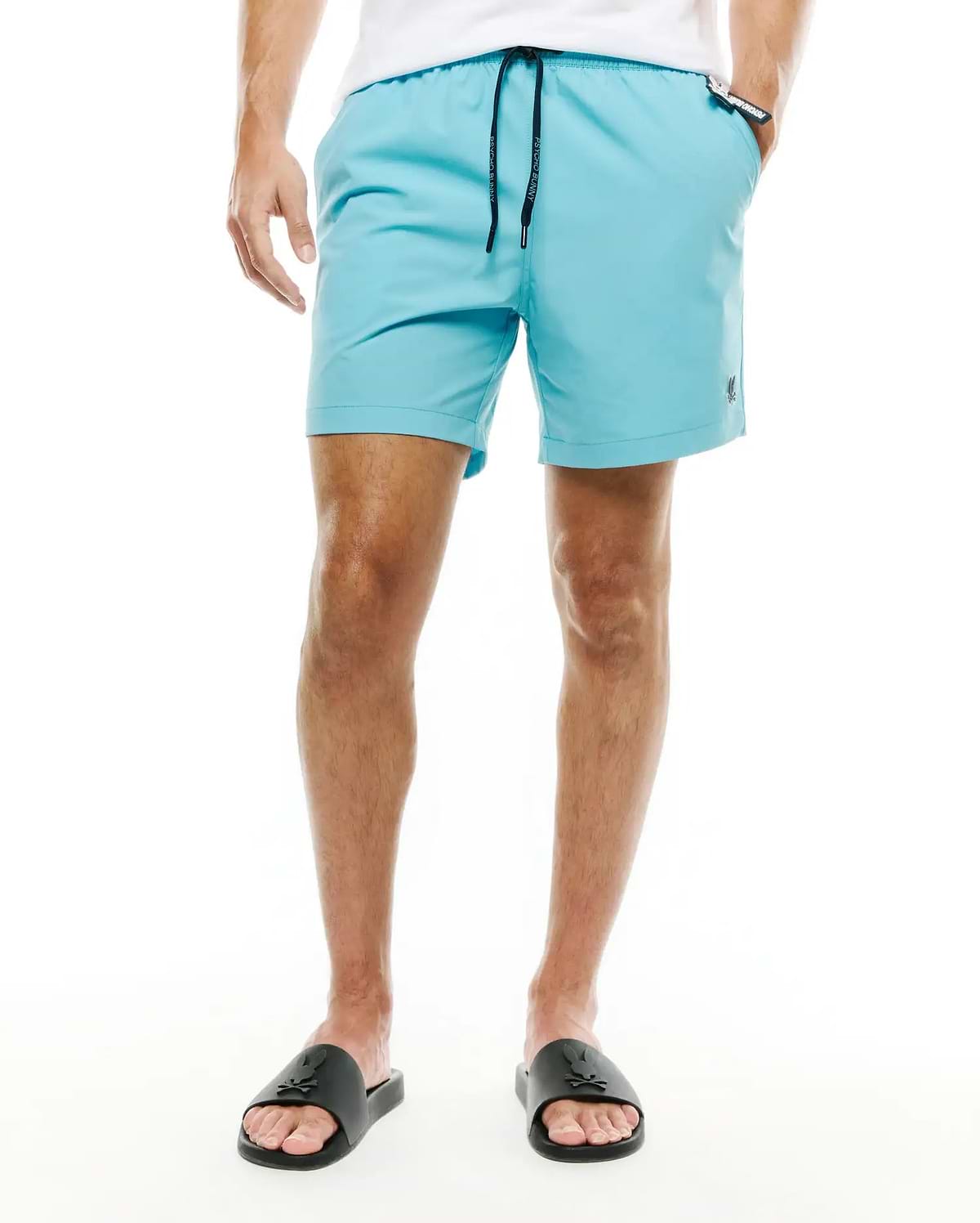 Mens Samos Hydrochromic Swim Trunks in aqua blue, featuring a classic fit, smooth quick-dry fabric, dark blue drawstring with white Psycho Bunny text, and a small black embroidered bunny skull logo on the left leg. (2)