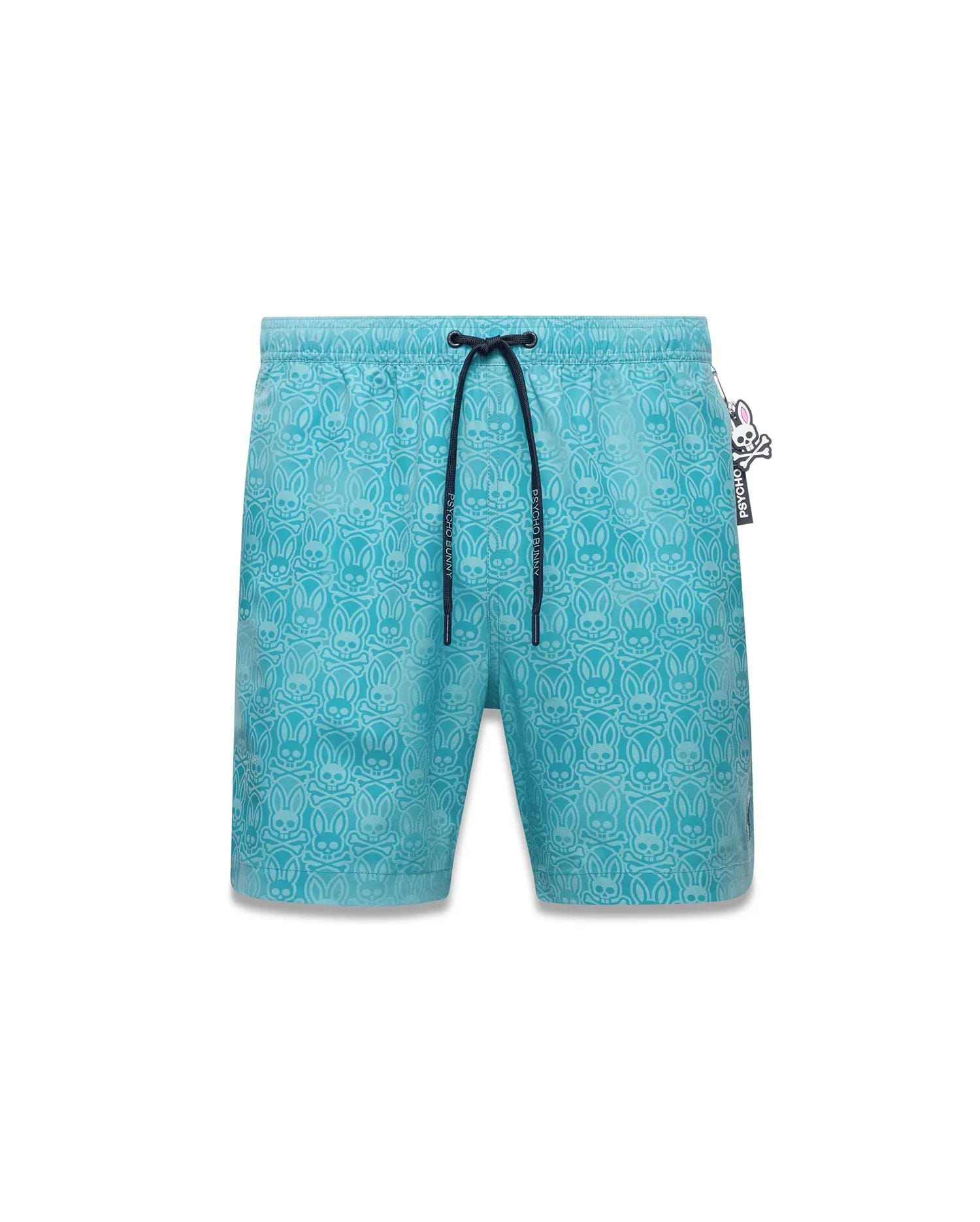 Mens Samos Hydrochromic Swim Trunks, aqua blue with an all-over tonal Psycho Bunny skull and crossbones pattern. Features an elastic waist, dark blue drawstring with Psycho Bunny text, and a side logo tag. (6)