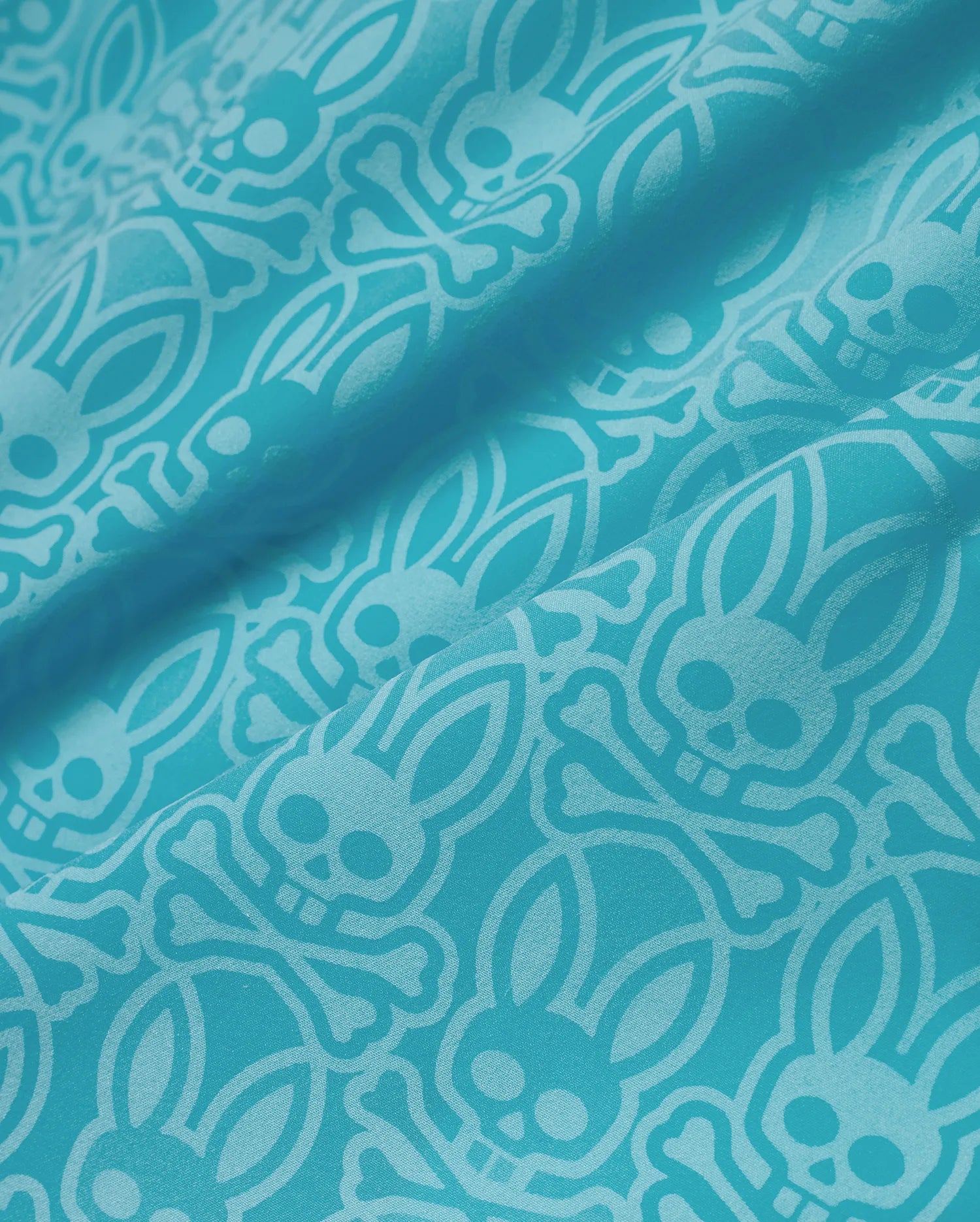 Mens Samos Hydrochromic Swim Trunks in vibrant teal, featuring a tone-on-tone all-over pattern of the iconic Psycho Bunny skull and crossbones logo on a smooth, durable swim fabric. (7)