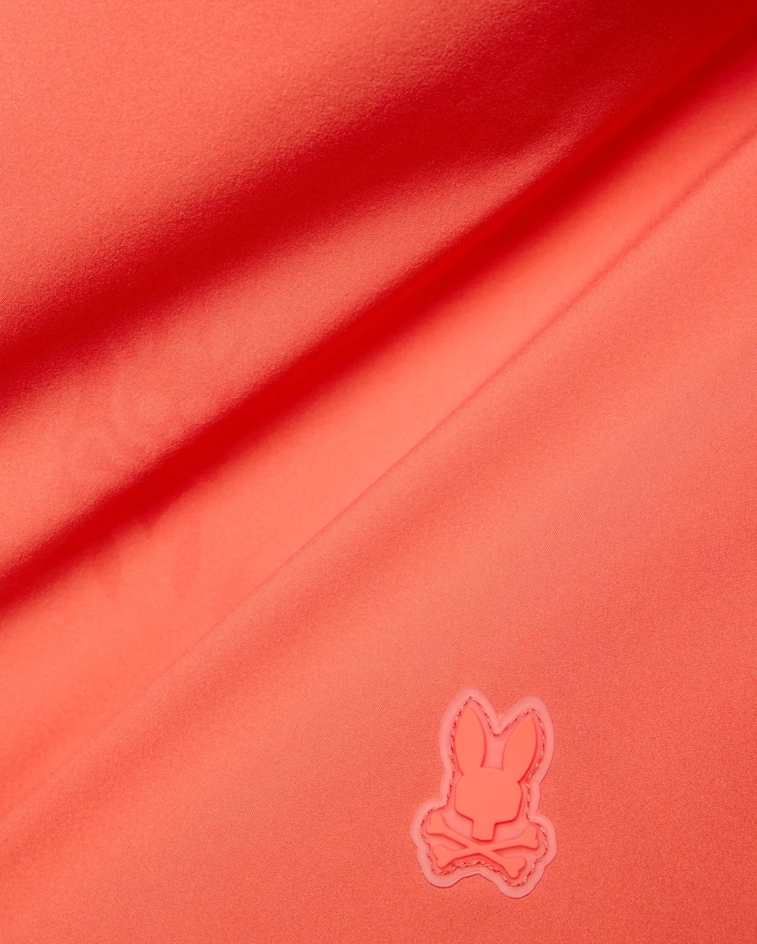 Vibrant Coral Mens Samos Hydrochromic Printed Swim Trunk, crafted from smooth premium swimwear fabric, featuring a raised tonal rubberized Psycho Bunny skull logo. (7)