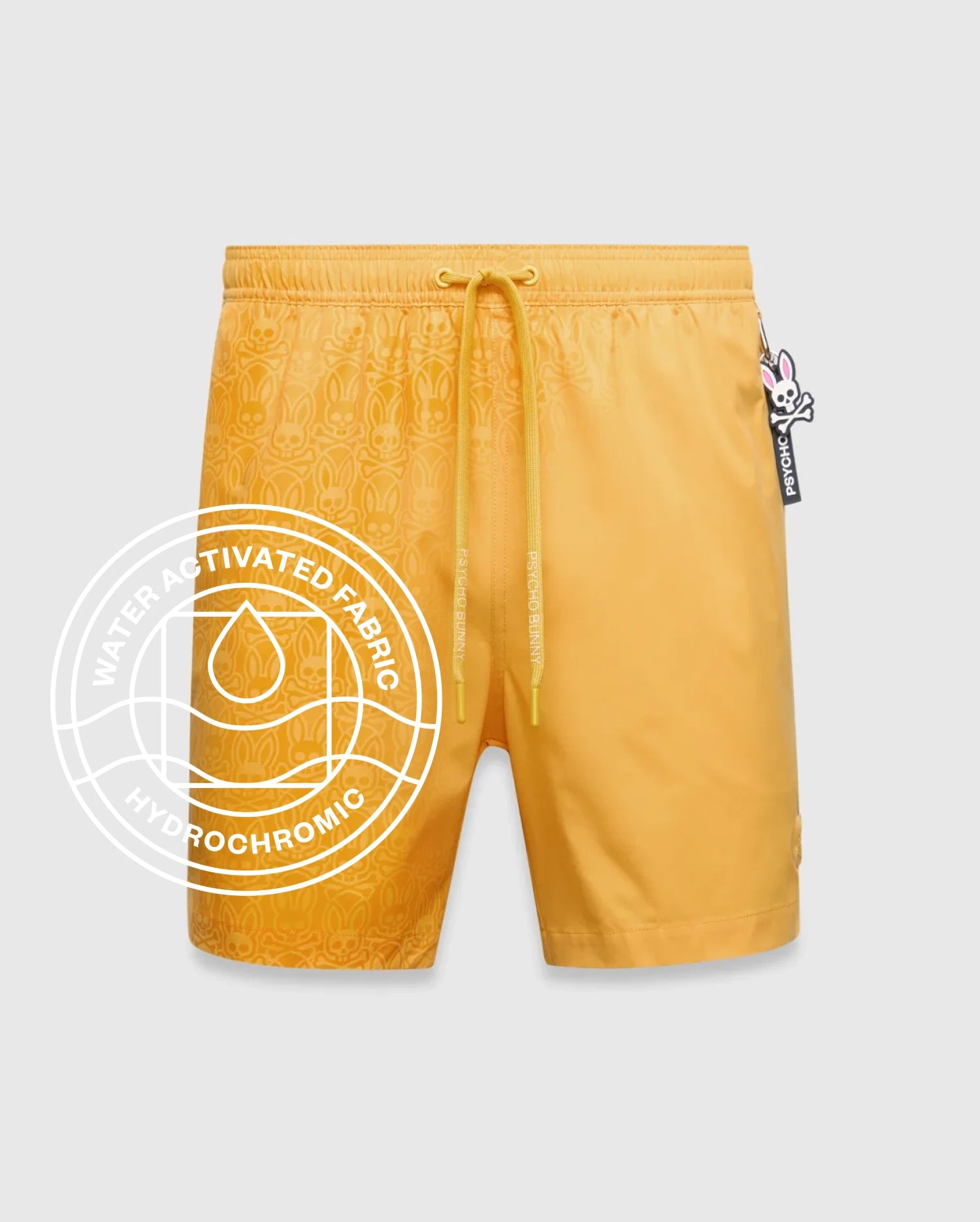 Goldenrod yellow Mens Samos Hydrochromic Printed Swim Trunk with a water-activated tonal bunny skull pattern, elastic drawstring waist featuring Psycho Bunny text, and a small embroidered logo. (1)